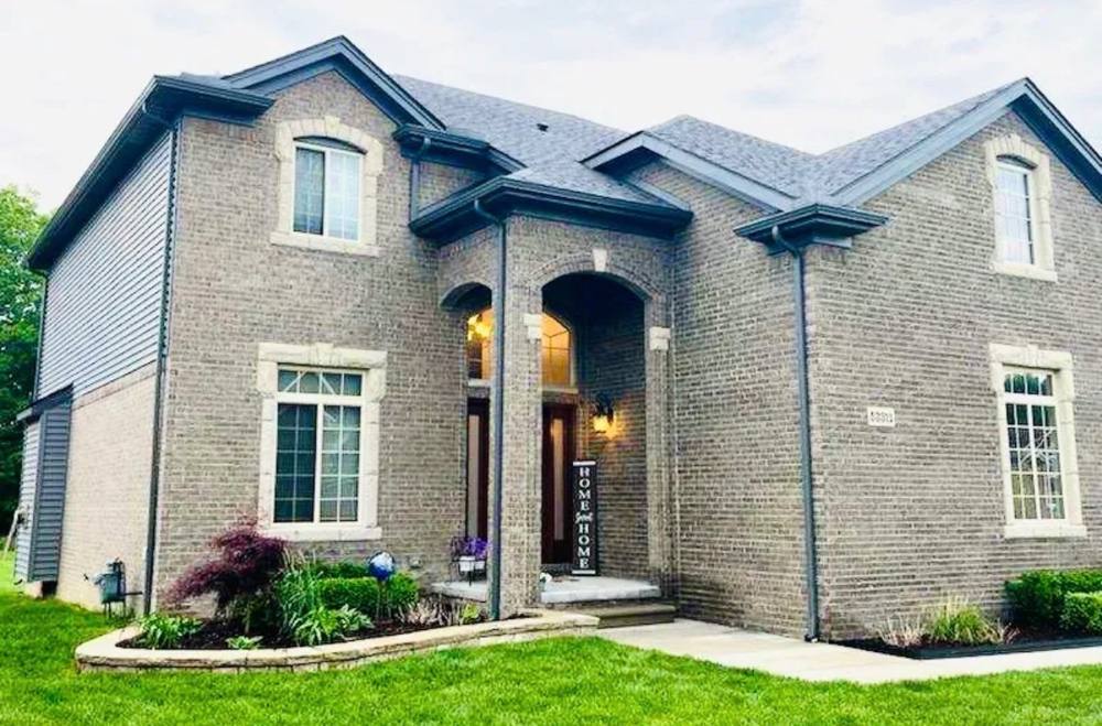 Brick two-story home with seamless gutter installation