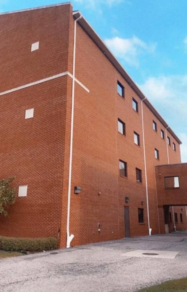 Commercial brick building with white downspout installation